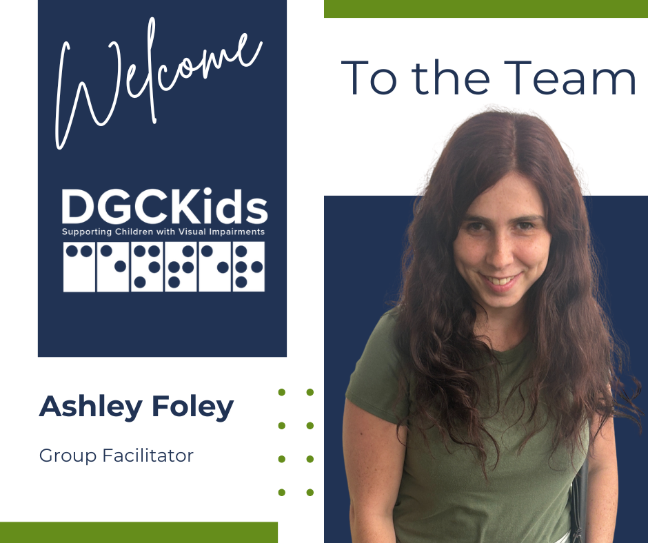 A welcome graphic introduces Ashley Foley as a new Group Facilitator at DGCKids. On the left side, a navy-blue box features the word “Welcome” in script above the DGCKids logo, which includes braille dots and the tagline “Supporting Children with Visual Impairments.” Below, the text reads “Ashley Foley, Group Facilitator.” On the right side, Ashley is smiling, with long wavy brown hair and wearing a green t-shirt, set against a navy-blue and white background with green accent bars.